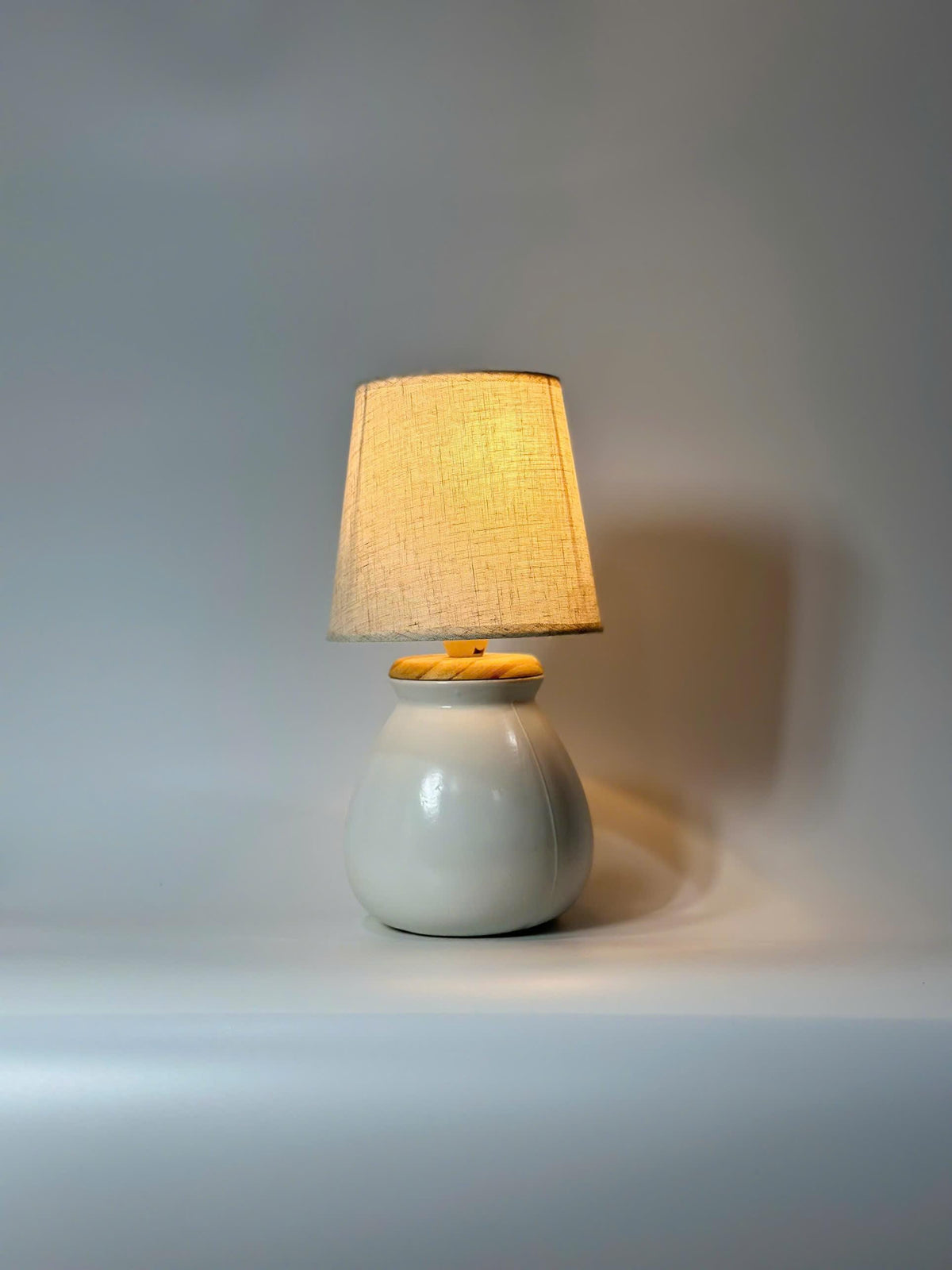 Handmade ceramic table lamp with warm ambient light. Simple form, gentle glow, timeless mood.