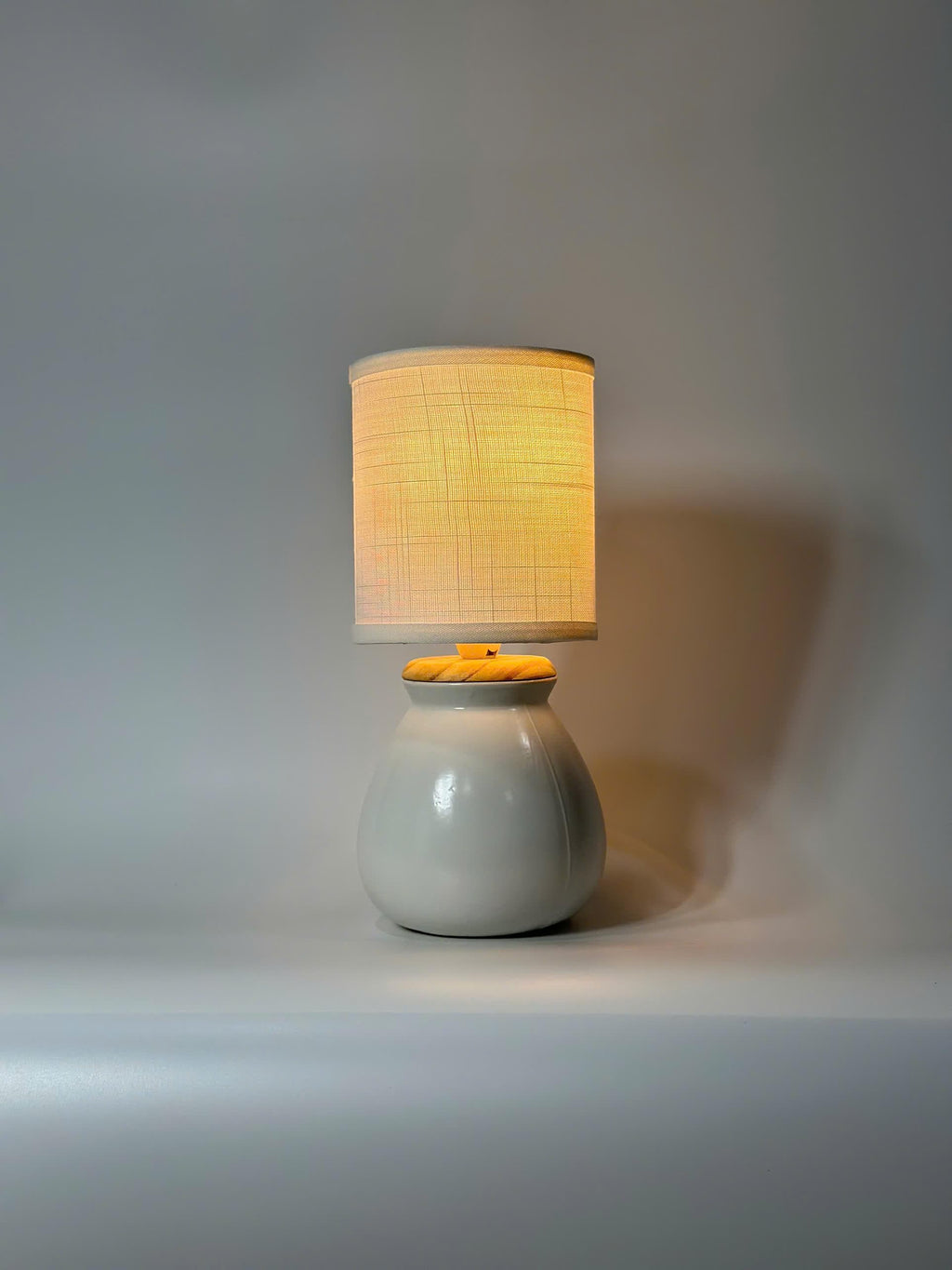 Handmade ceramic table lamp with warm ambient light. Simple form, gentle glow, timeless mood.