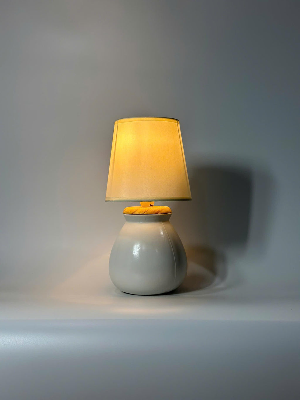 Handmade ceramic table lamp with warm ambient light. Simple form, gentle glow, timeless mood.