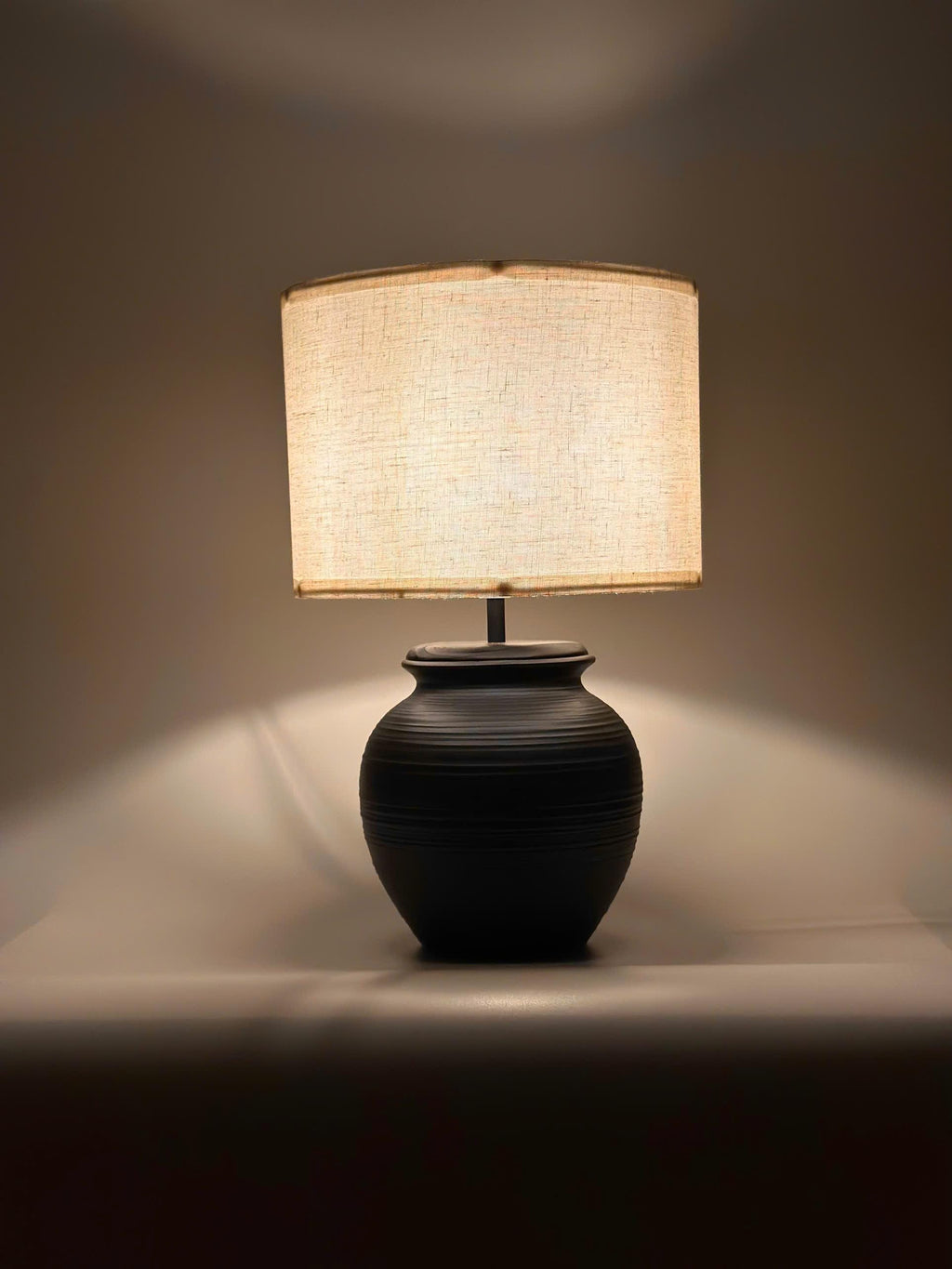Handmade ceramic table lamp with warm ambient light. Simple form, gentle glow, timeless mood. Bat Trang ceramic, Vietnam.