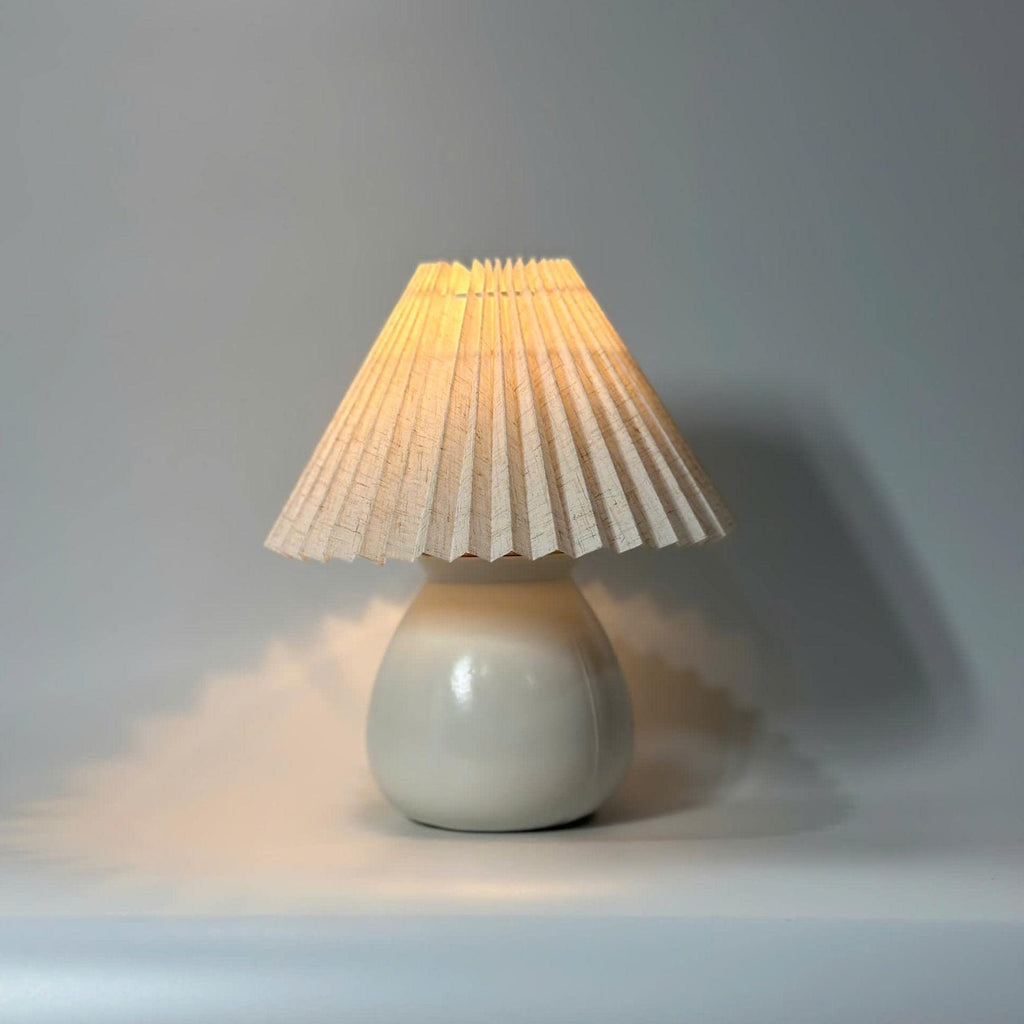 Handmade ceramic table lamp with warm ambient light. Simple form, gentle glow, timeless mood.
