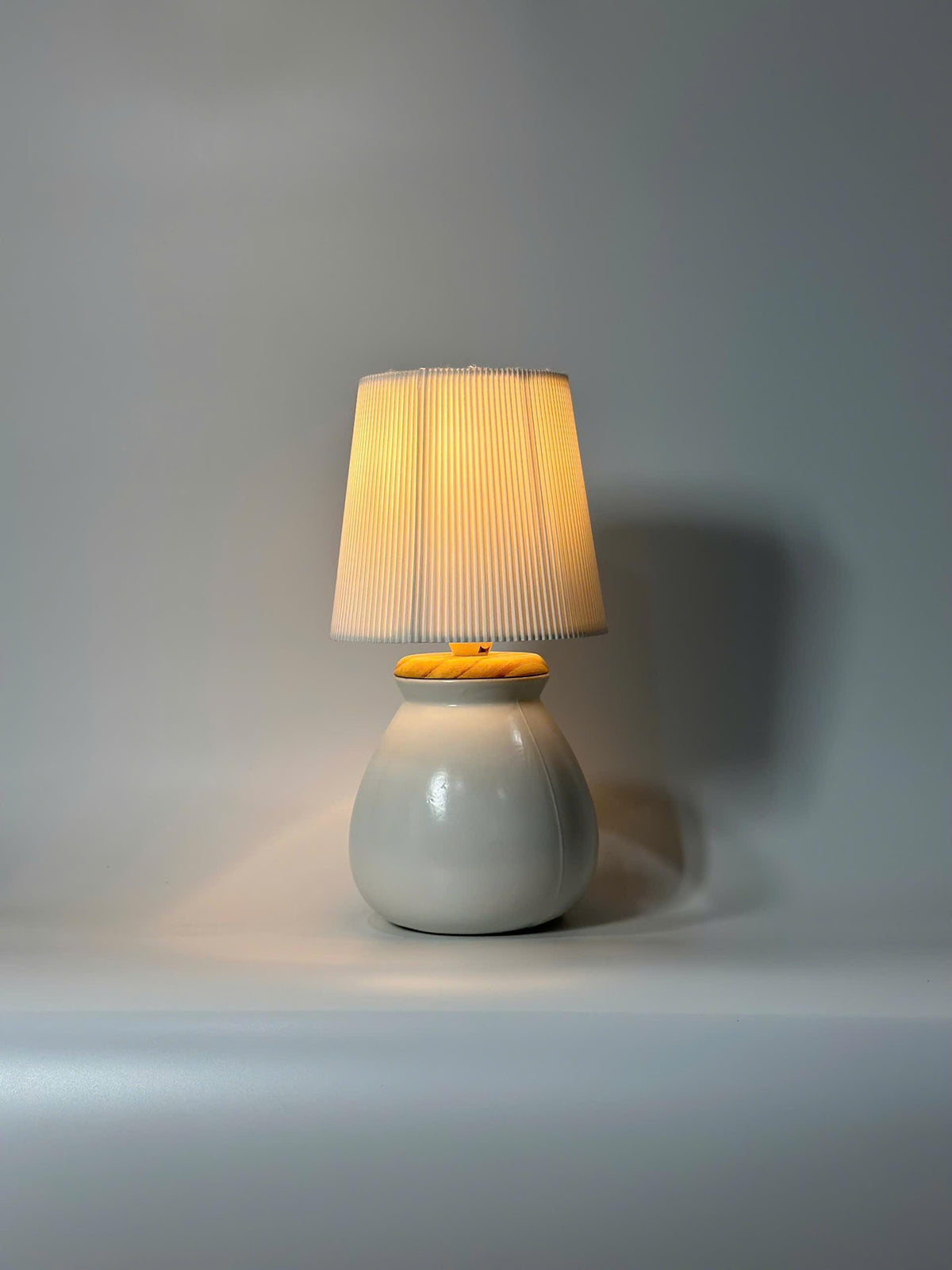 Handmade ceramic table lamp with warm ambient light. Simple form, gentle glow, timeless mood.