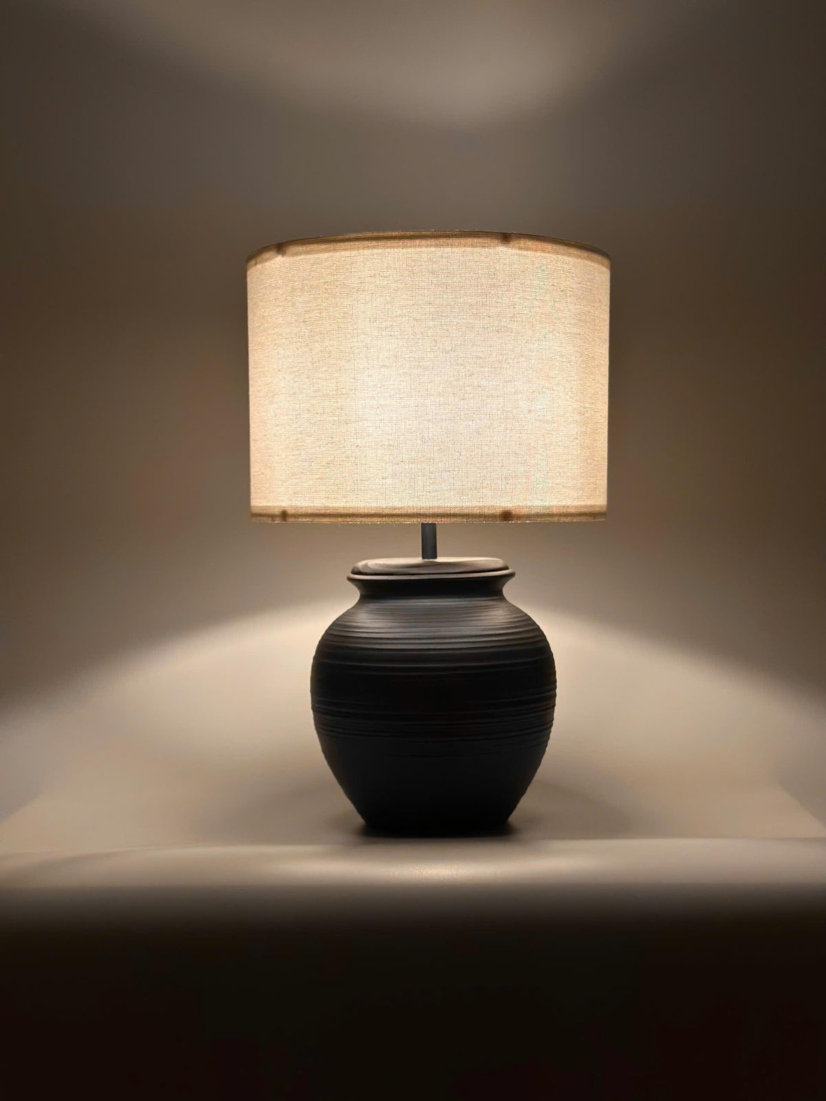 Handmade ceramic table lamp with warm ambient light. Simple form, gentle glow, timeless mood. Bat Trang ceramic, Vietnam.