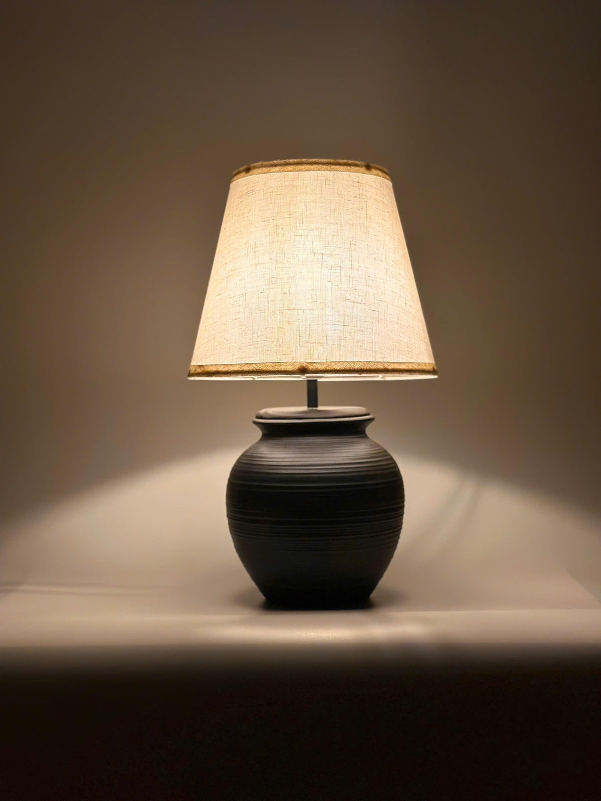 Handmade ceramic table lamp with warm ambient light. Simple form, gentle glow, timeless mood. Bat Trang ceramic, Vietnam.
