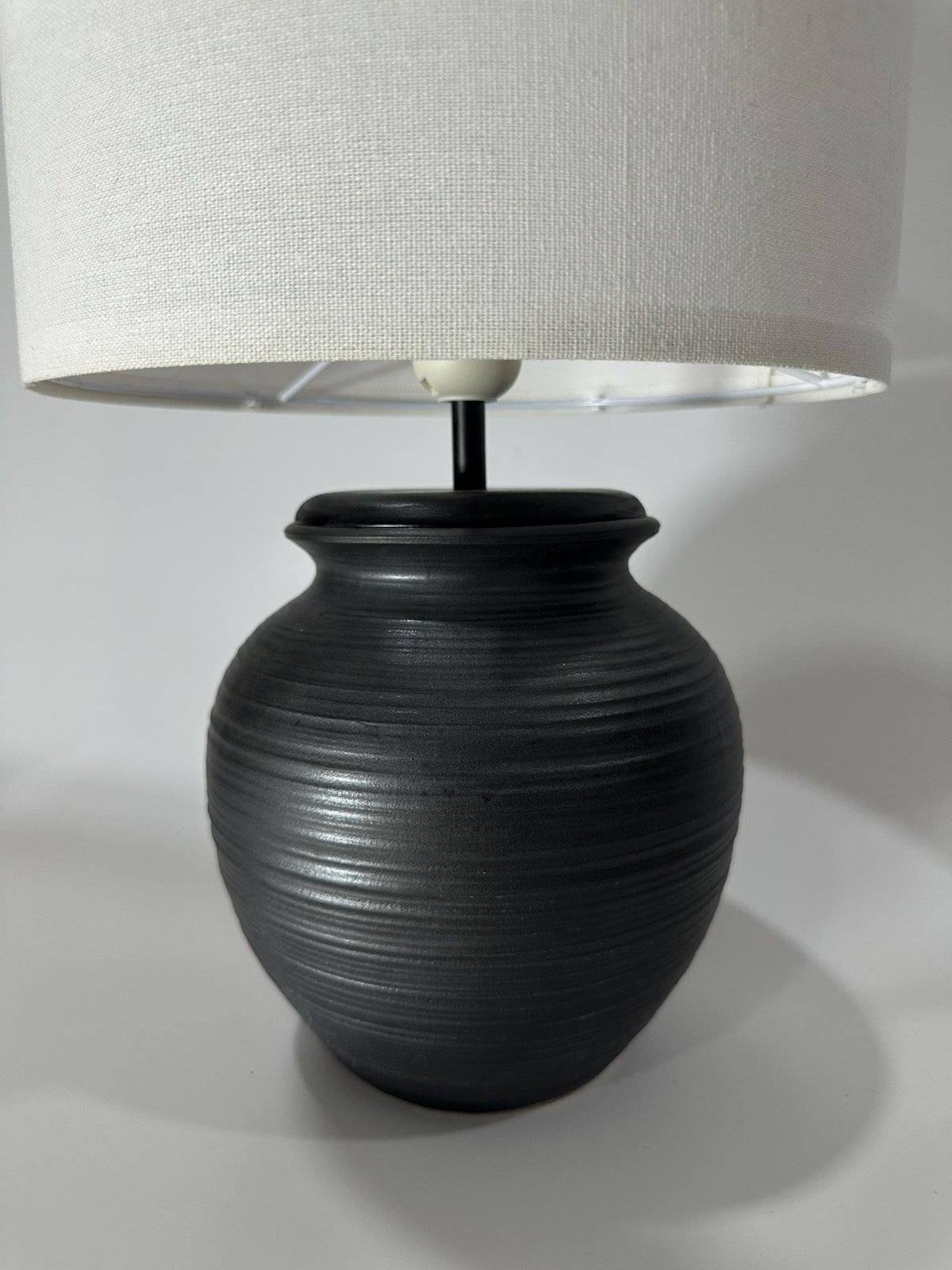 Handmade ceramic table lamp with warm ambient light. Simple form, gentle glow, timeless mood. Bat Trang ceramic, Vietnam.