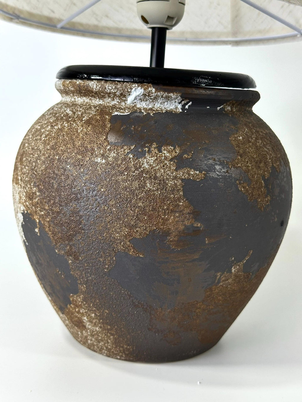 Handcrafted ceramic lamp with an aged earthen texture and timeless patina, paired with a warm linen shade for a soulful wabi-sabi glow.