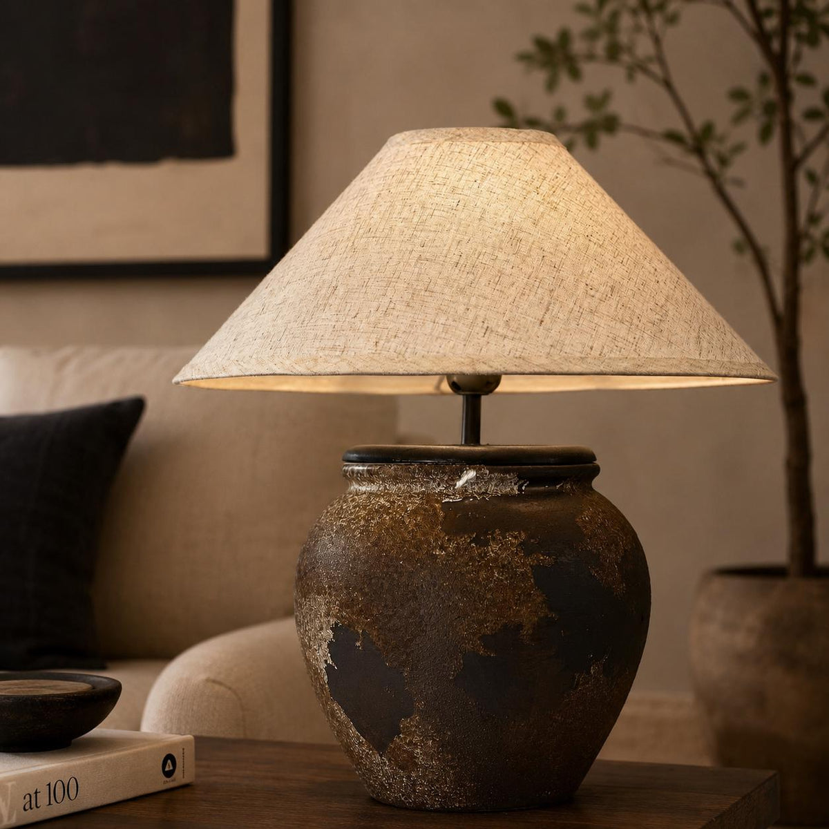 Handcrafted ceramic lamp with an aged earthen texture and timeless patina, paired with a warm linen shade for a soulful wabi-sabi glow.