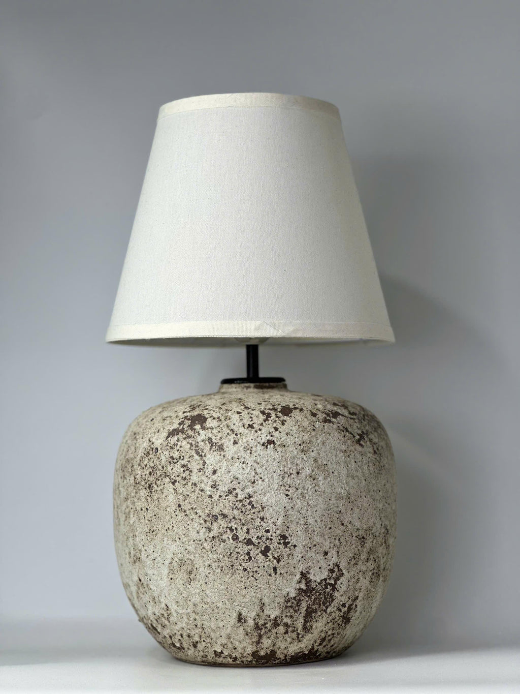 Handcrafted ceramic lamp with an antique-inspired finish. Timeless texture, soft glow, endless warmth