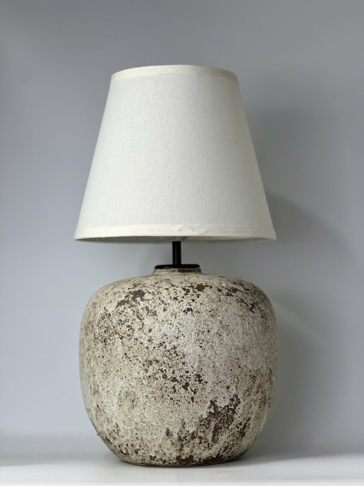 Handcrafted ceramic lamp with an antique-inspired finish. Timeless texture, soft glow, endless warmth
