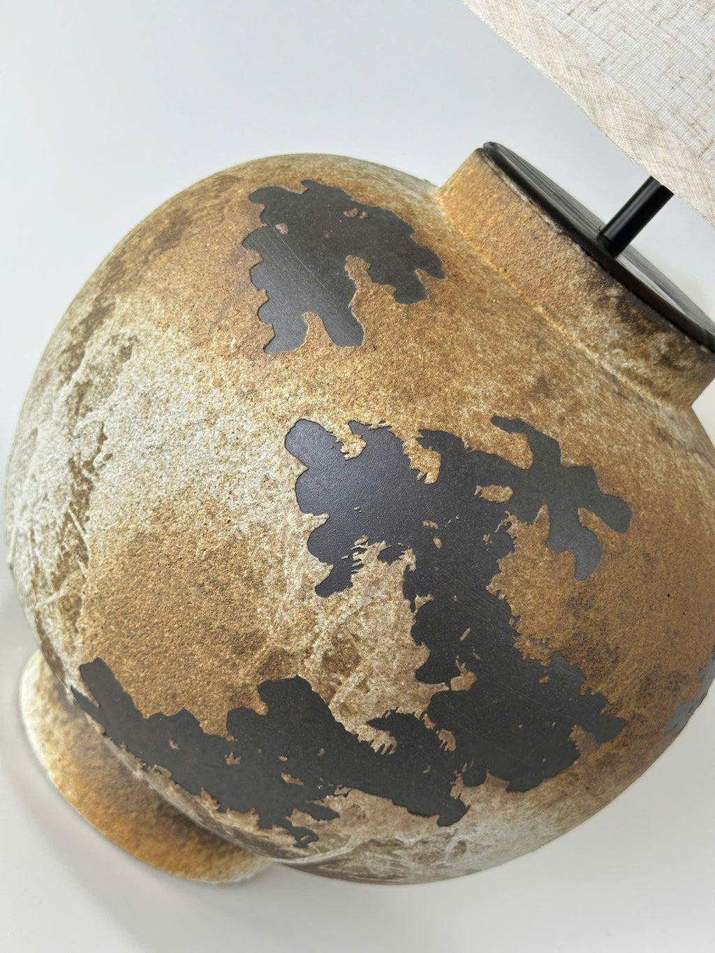 Handcrafted ceramic table lamp with rustic earthy textures, creating a warm, cozy glow for wabi-sabi, Japandi, and modern homes.