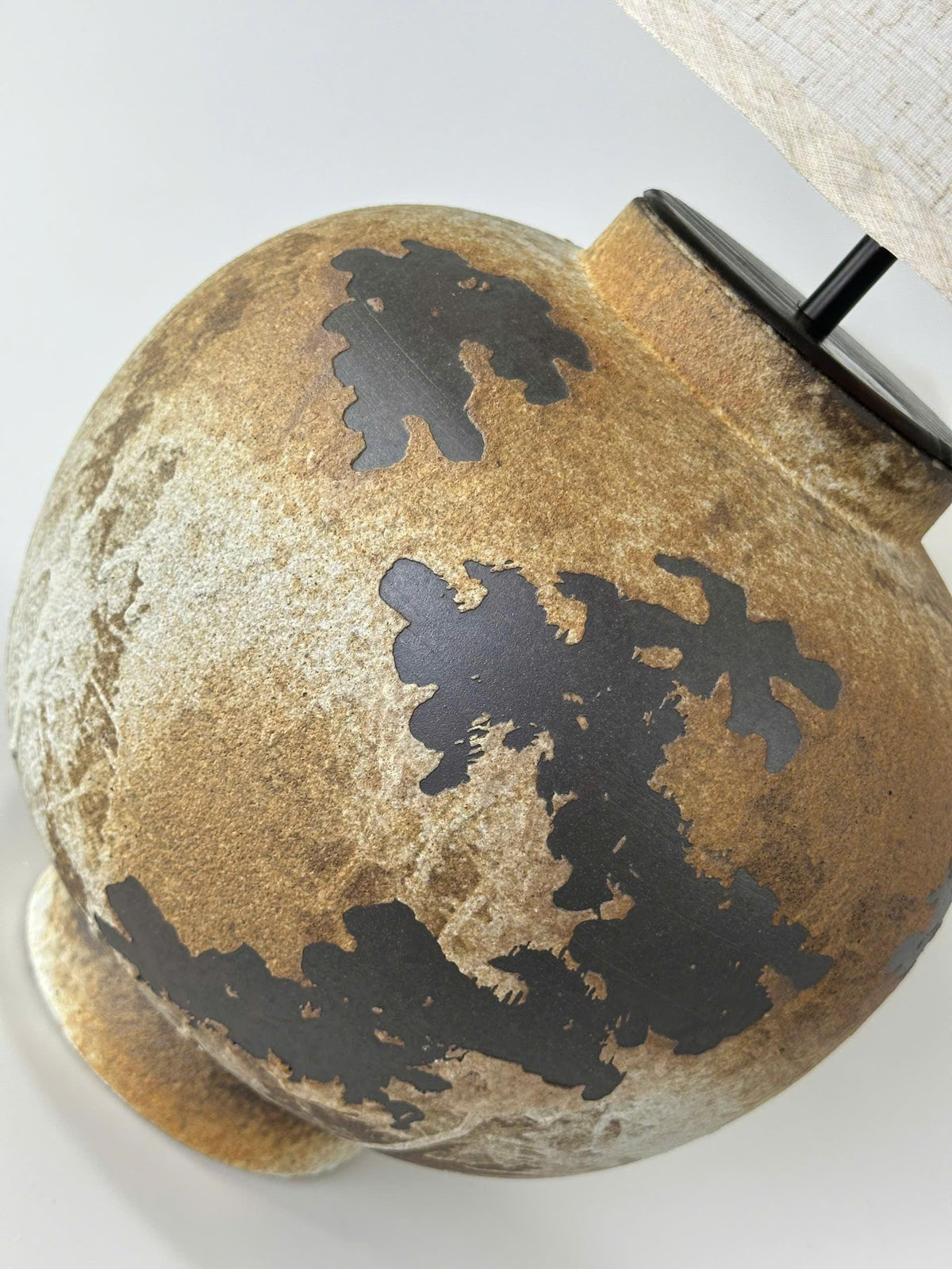 Handcrafted ceramic table lamp with rustic earthy textures, creating a warm, cozy glow for wabi-sabi, Japandi, and modern homes.