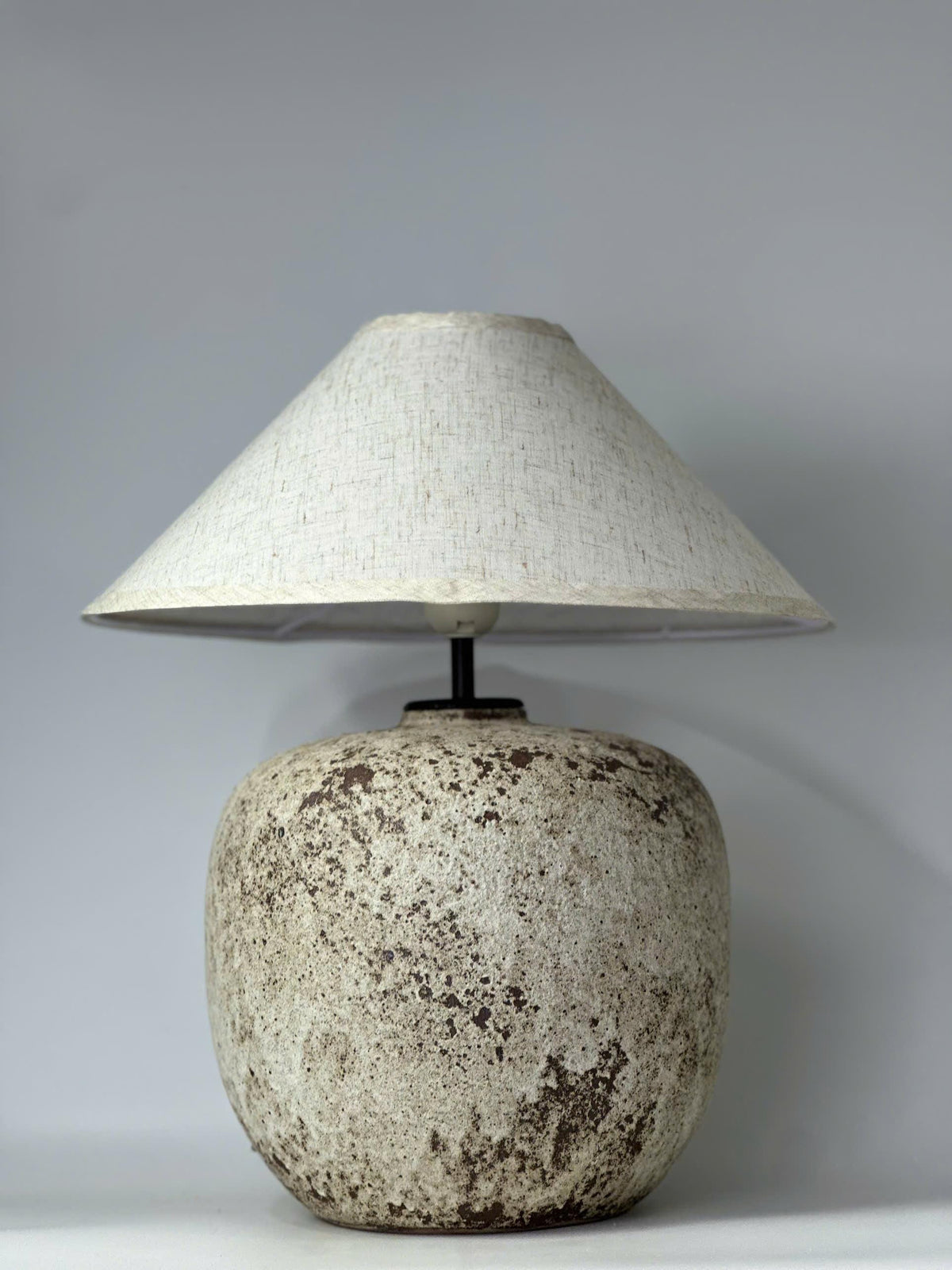 Handcrafted ceramic lamp with an antique-inspired finish. Timeless texture, soft glow, endless warmth