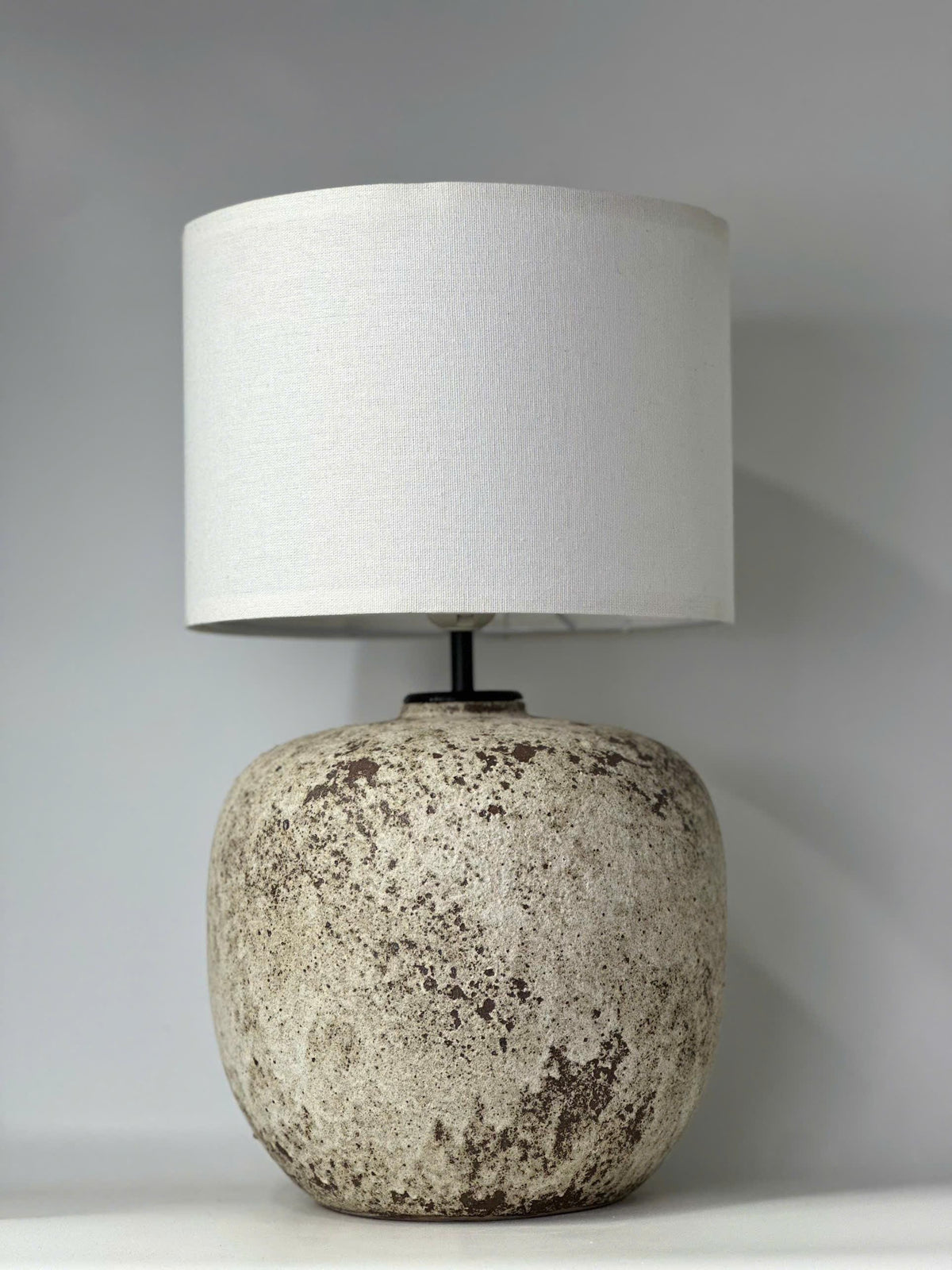 Handcrafted ceramic lamp with an antique-inspired finish. Timeless texture, soft glow, endless warmth