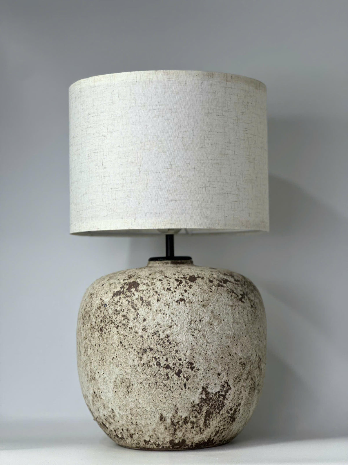 Handcrafted ceramic lamp with an antique-inspired finish. Timeless texture, soft glow, endless warmth