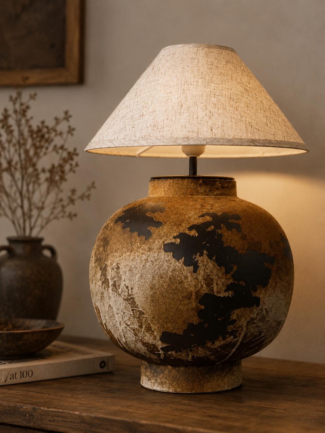 Handcrafted ceramic table lamp with rustic earthy textures, creating a warm, cozy glow for wabi-sabi, Japandi, and modern homes.