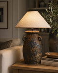 Handcrafted ceramic table lamp with rustic earthy textures, creating a warm, cozy glow for wabi-sabi, Japandi, and modern homes.