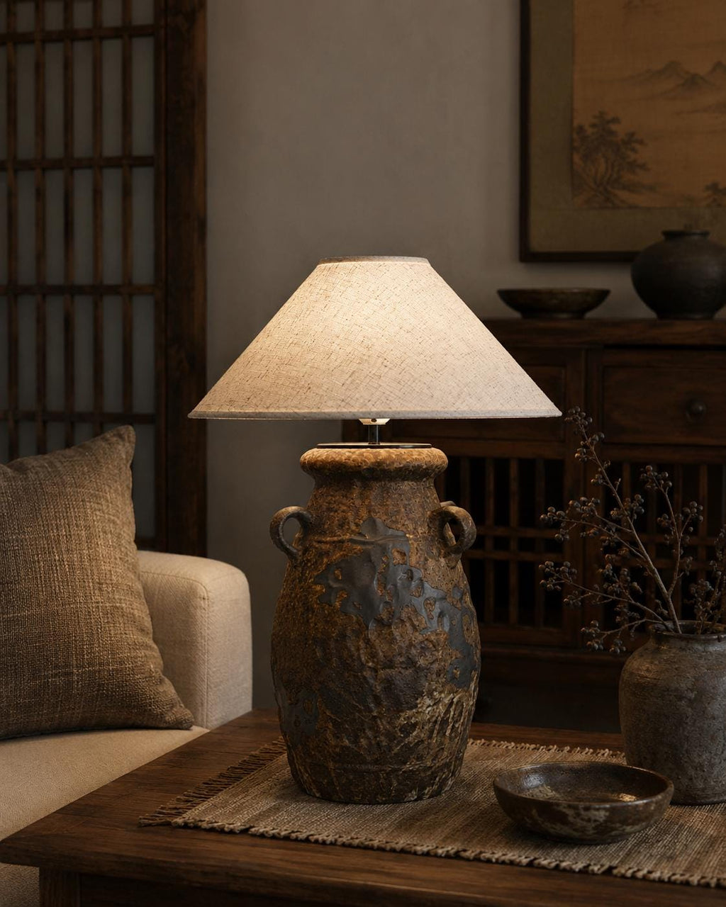 Handcrafted ceramic table lamp with rustic earthy textures, creating a warm, cozy glow for wabi-sabi, Japandi, and modern homes.