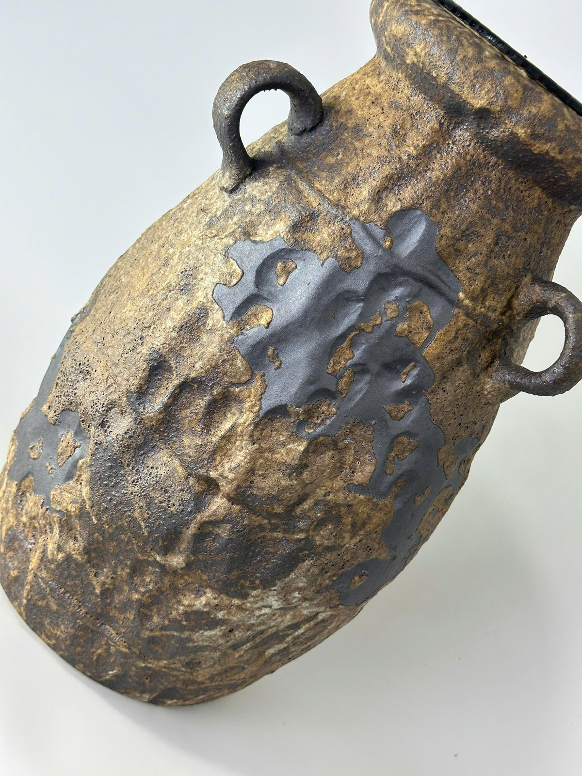 Handcrafted ceramic table lamp with rustic earthy textures, creating a warm, cozy glow for wabi-sabi, Japandi, and modern homes.